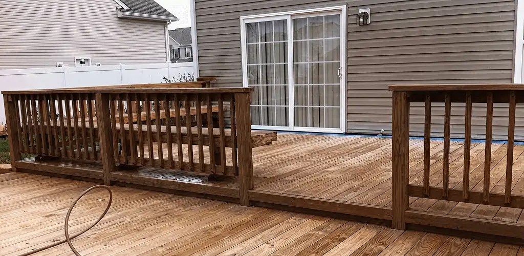 Deck sealing service protecting a backyard wood deck and railings in Marietta, GA