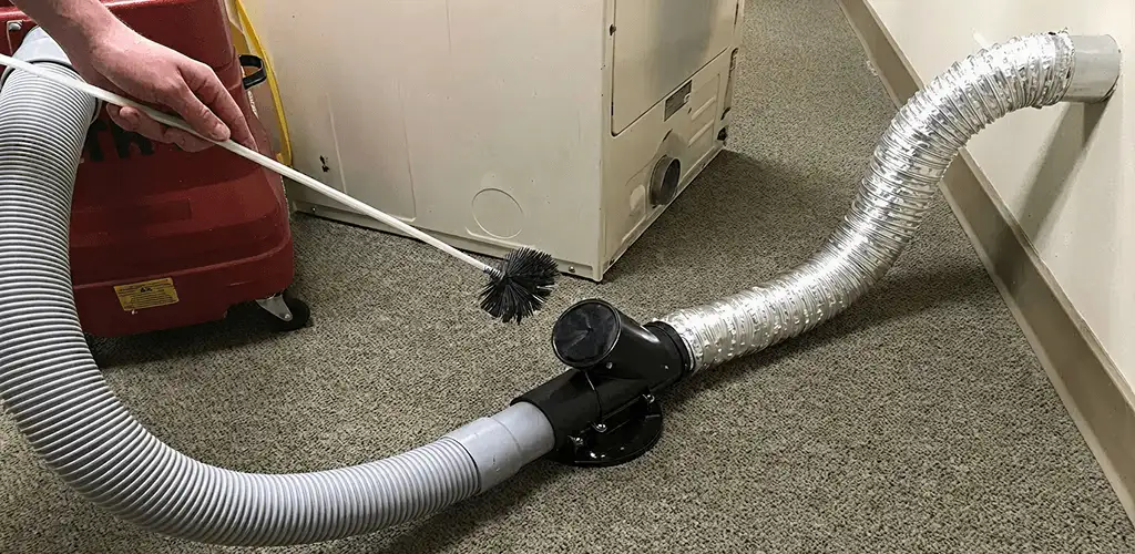 Dryer vent cleaning service removing lint from a dryer duct connection in Marietta, GA