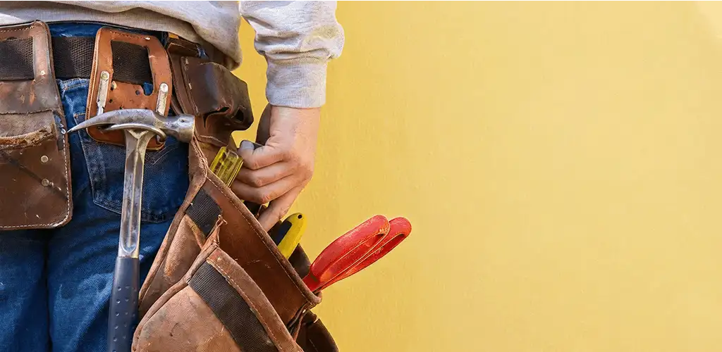 Handyman with tool belt ready for home repairs and maintenance in Marietta, GA