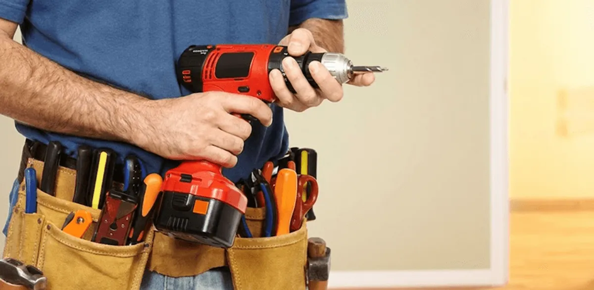 Handyman holding a power drill for home repairs and installations in Marietta, GA