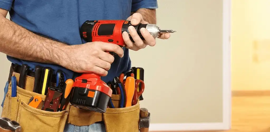 Handyman holding a power drill for home repairs and installations in Marietta, GA