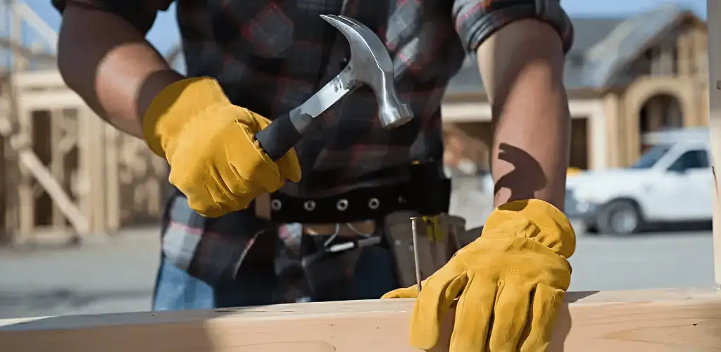 Handyman fixing wood trim with a hammer for home repairs in Marietta, GA